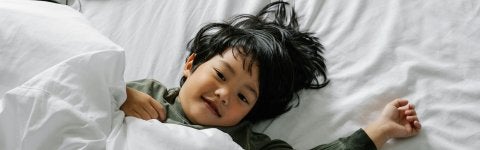 A child resting in bed.