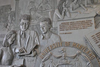 Photo of mural in Benjamin lobby featuring professor and two students